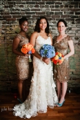 Bridesmaid bouquets with bright orange dahlias and zinnias, and a bridal bouquet featuring light blue hydrangea, by Floressence.