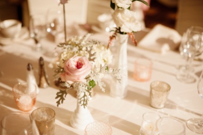 Sweetly simple centerpieces in blush and white tones accent the tables at Ray's Boathouse. Flowers by Floressence.
