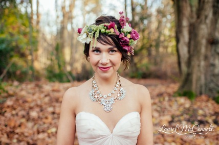 A bride's floral hair garland featuring garden spray roses, anemones, amaranthus, and berries in hot pink, green, and white. By Floressence.