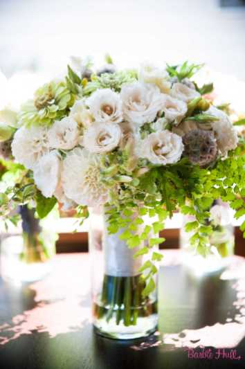 Bridal bouquet featuring fully blown White Majolika spray roses, maidenhair fern, white dahlias, and green zinnias, by Floressence.